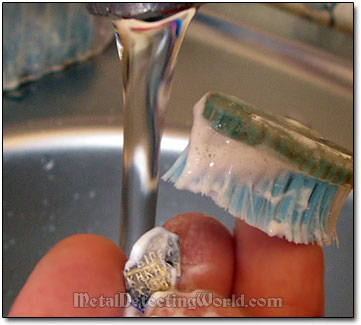 Cleaning a Silver Coin with Toothbrush After Lemon Acid Bath