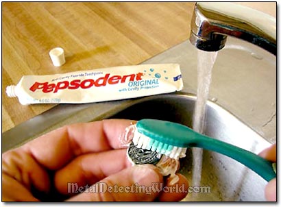 Cleaning Coin with a Toothbrush and Toothpaste