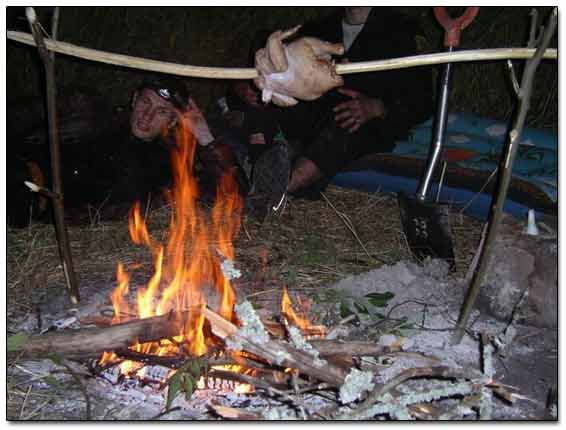 Cooking Chicken Over Camp-Fire